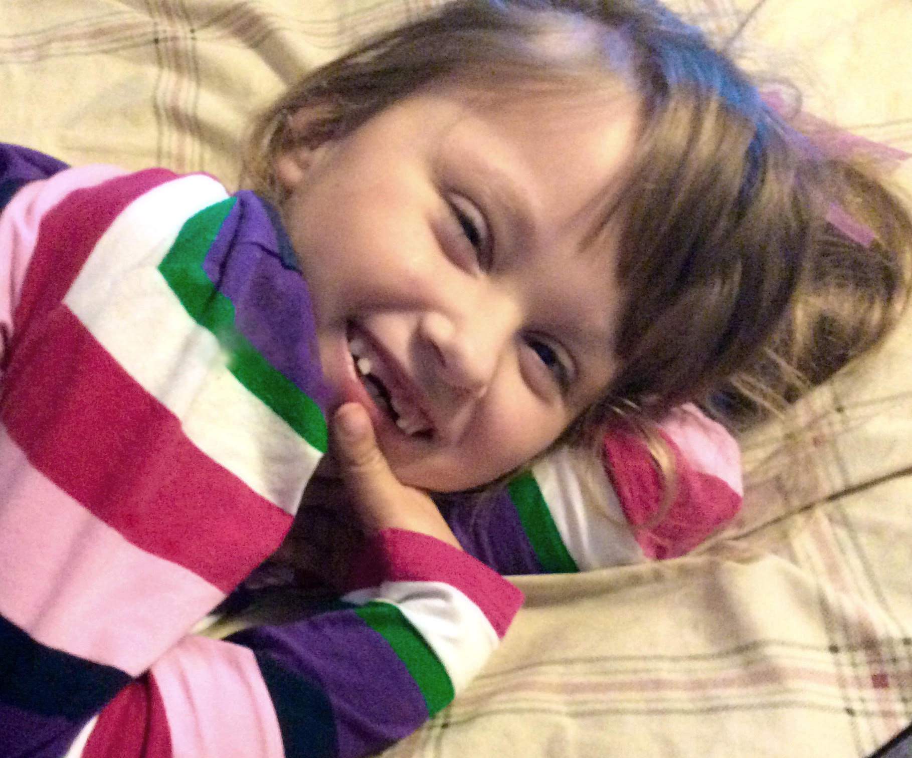 little girl smiling in crib