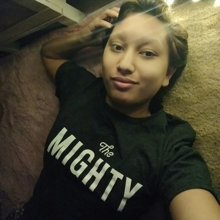 woman wearing Mighty t-shirt posing for camera
