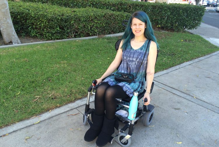 woman in wheelchair on sidewalk
