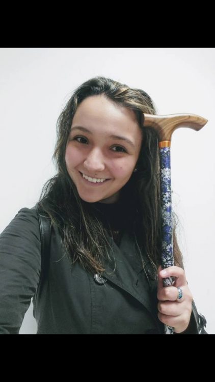 woman smiling holding cane