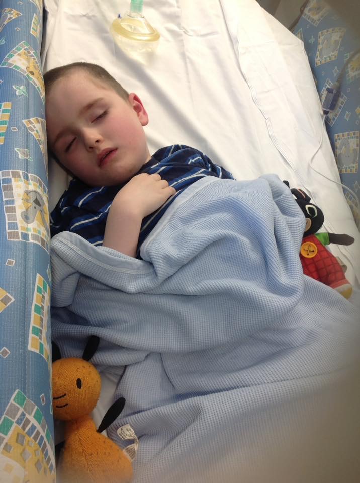 little boy asleep in the hospital
