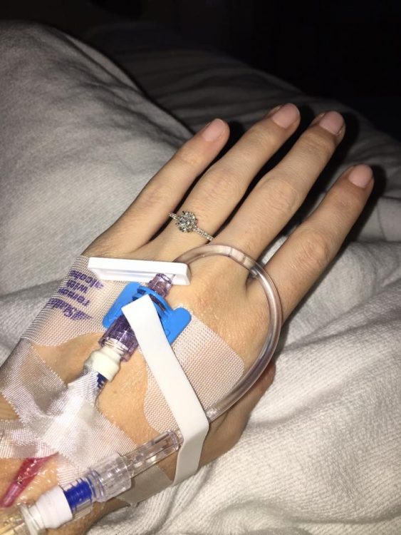 hand wearing engagement ring and iv line on hand