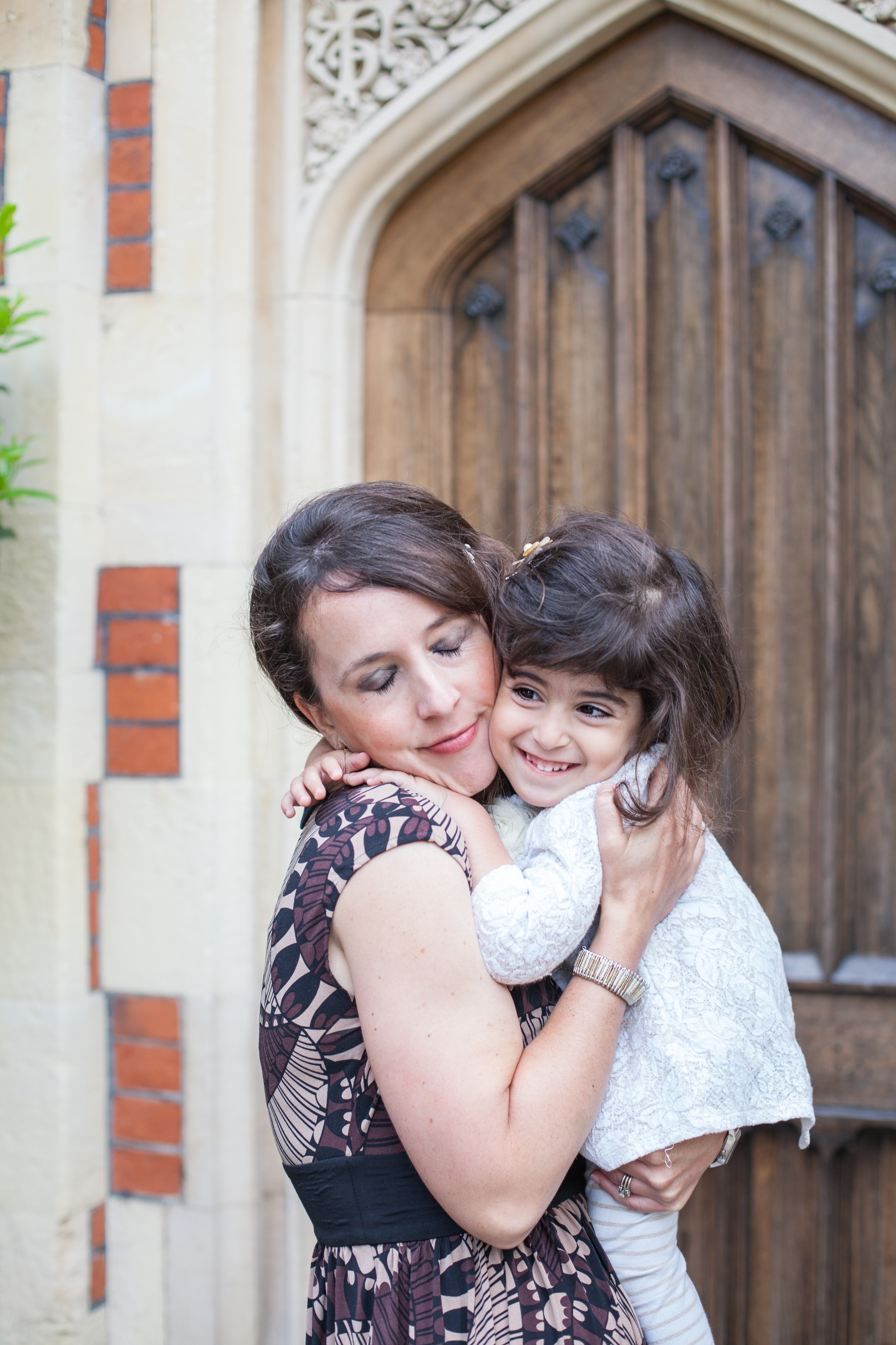 mom holding smiling daughter