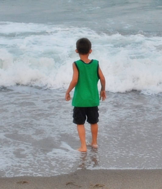 little boy running in ocean