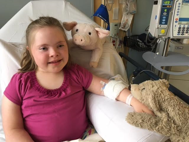 little girl in the hospital with stuffed animals