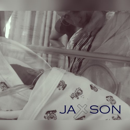 Black and white photo of baby Jaxson in the NICU with his mom looking down at him