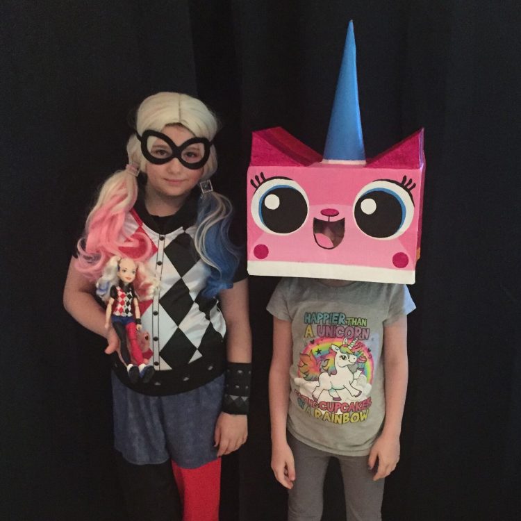 two children dressed as harley quinn and unikitty