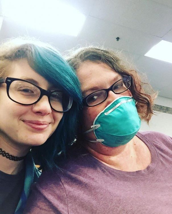 woman wearing surgical mask and teenage daughter