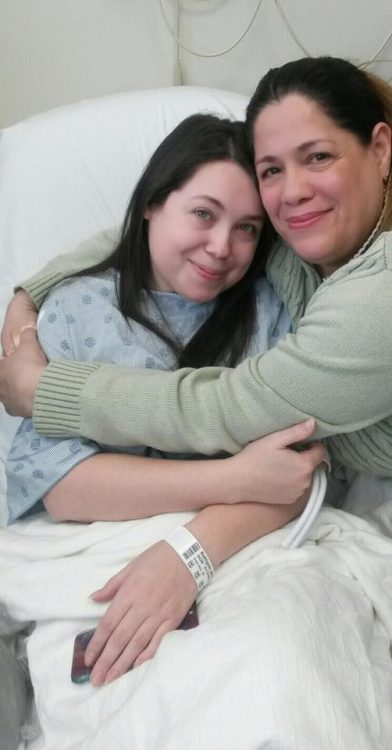 girl and mom hugging in hospital bed