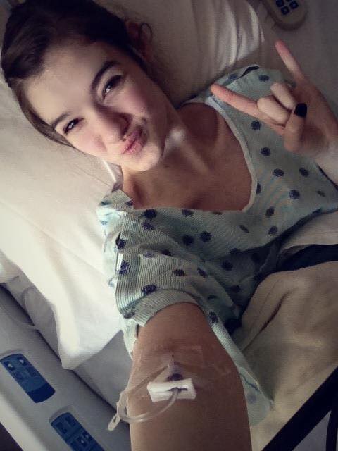 woman in hospital bed smiling