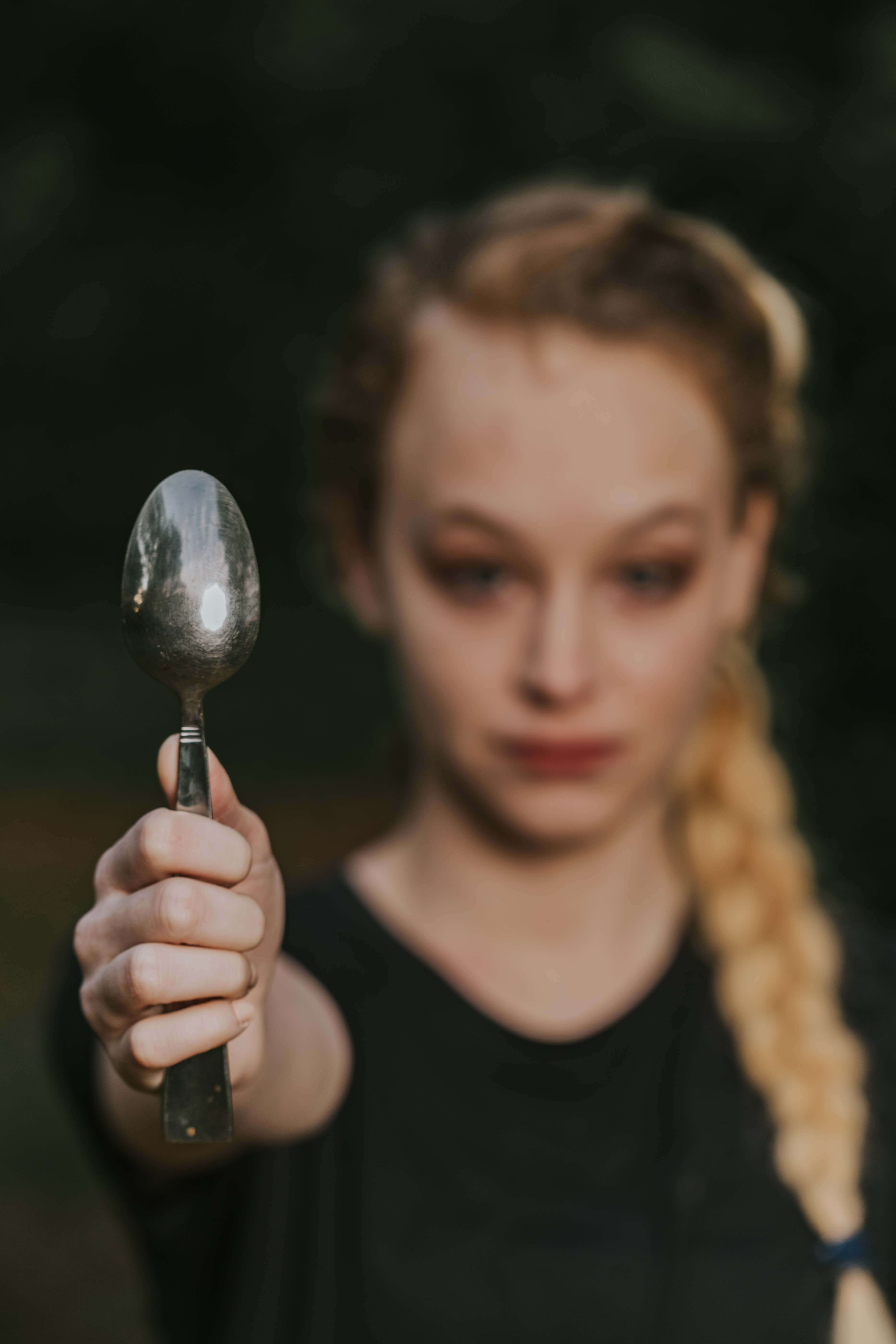close up of woman holding a spoon