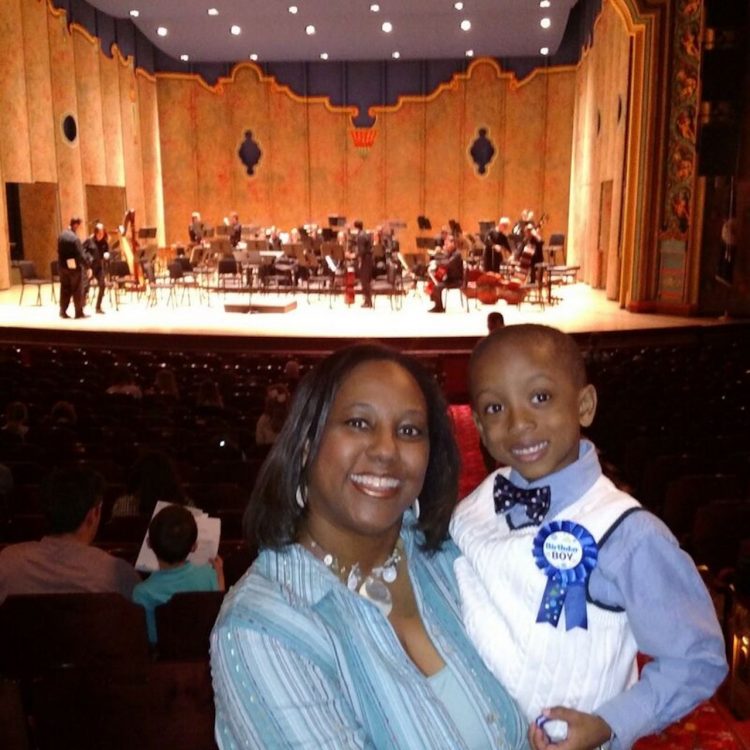 mother and son in the audience at a performance