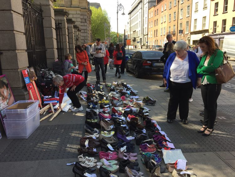 millions missing protest in dublin with rows of empty shoes on ground