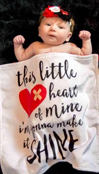 baby wrapped in heart blanket