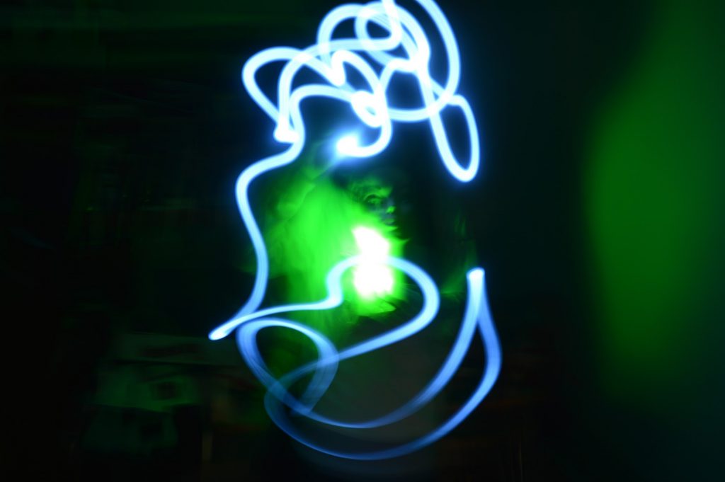 person with green light and blue light painting blur