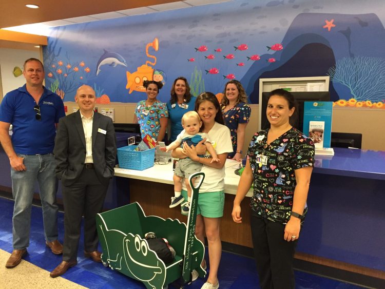 family holding their young son in the hospital with a team of nurses