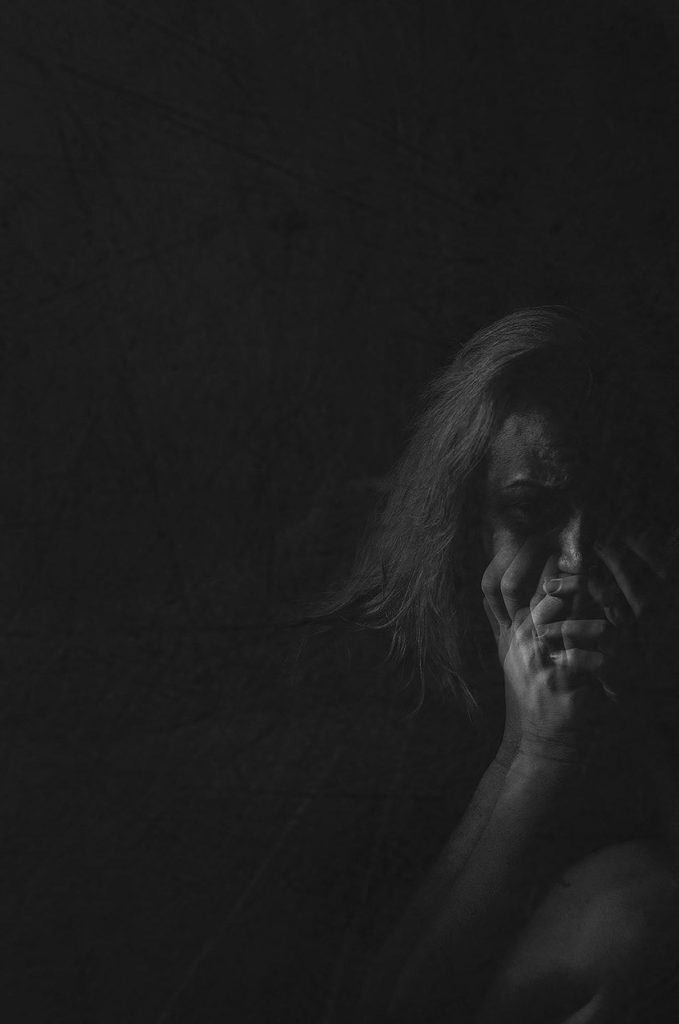 Black and white image of photographer's representation of how depression affects her hope - double exposure of woman's hands covering mouth