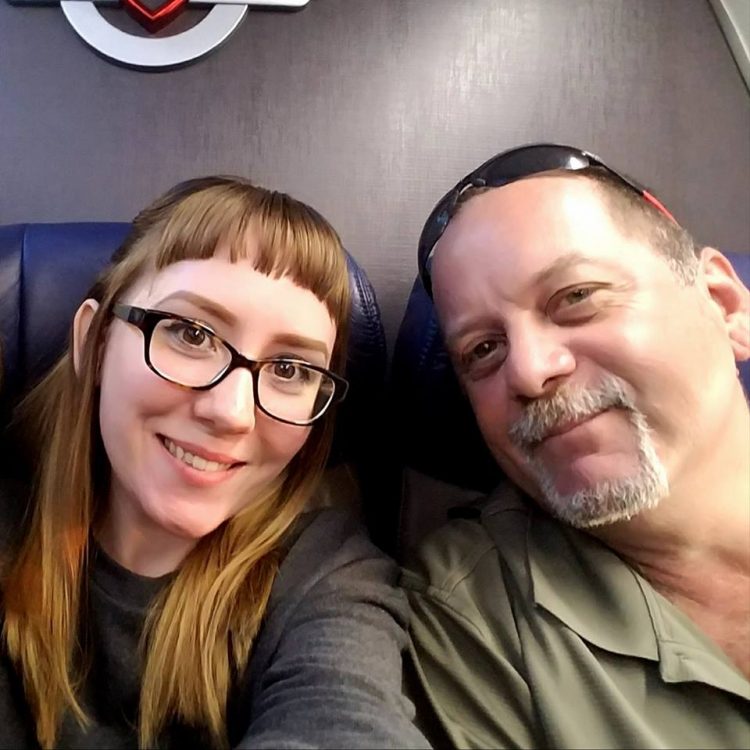 selfie of a woman and her dad on a plane