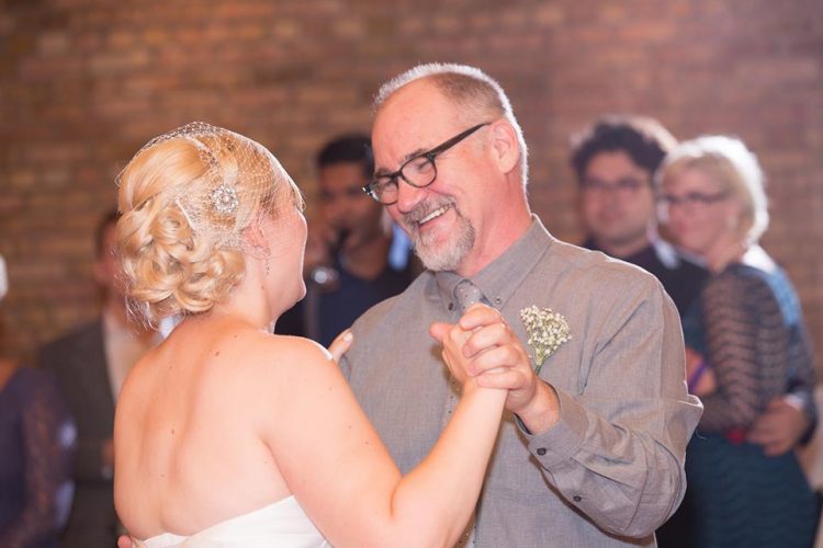 woman dancing with her dad on her wedding day