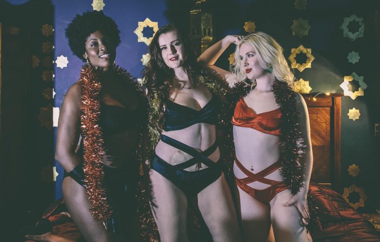 Three women with ostomies wearing lingerie