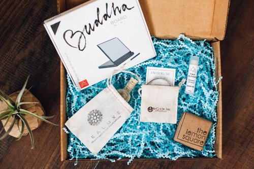 crate with blue confetti,buddha board, and soaps