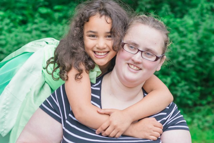 woman with daughter hugging her from behind