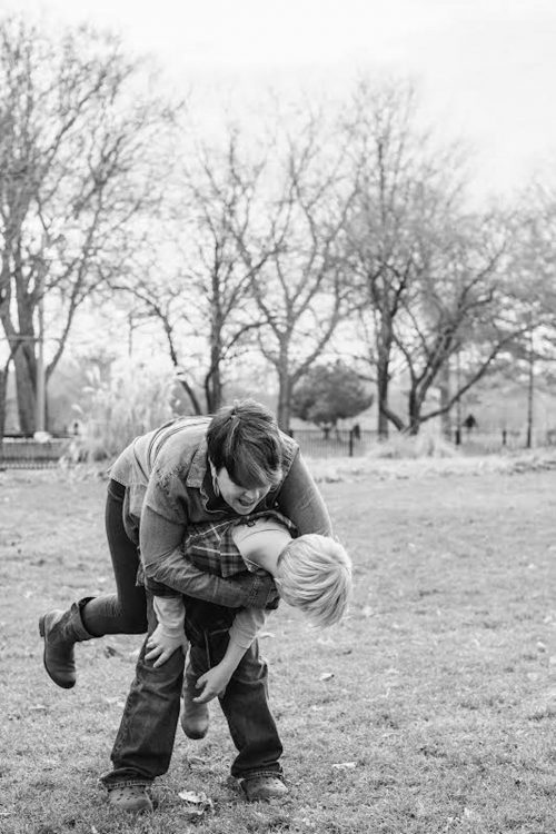 black and white photo of a woman playing outside with her son