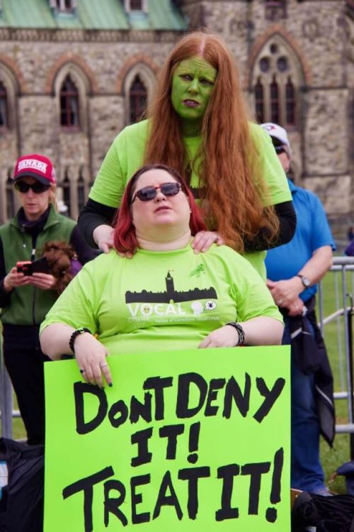 woman in a wheelchair at a lyme disease rally with her wife