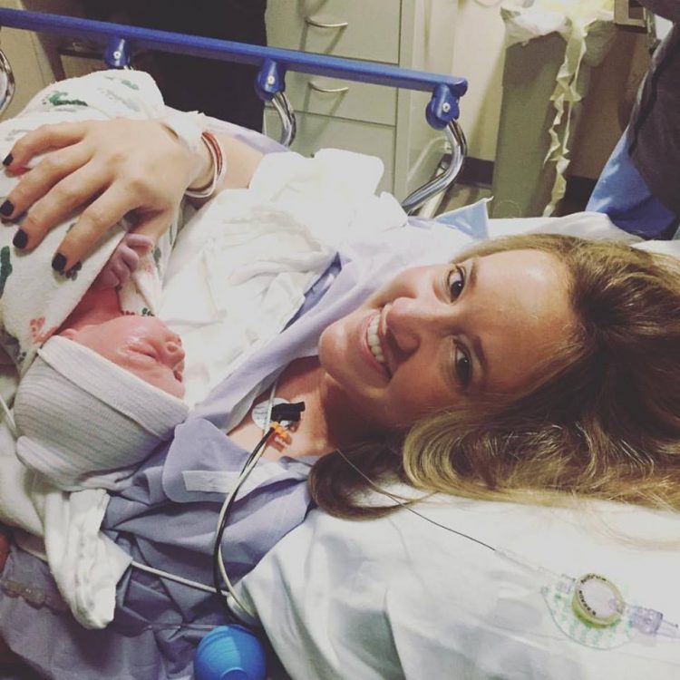 mother holding newborn baby in the hospital
