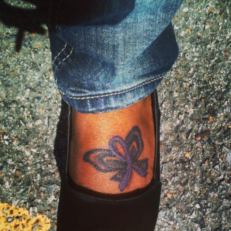 woman with purple butterfly on her foot