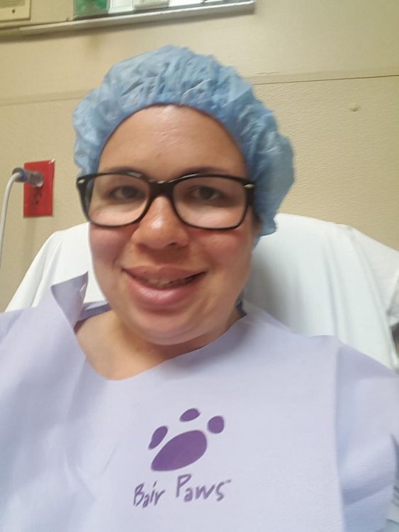 woman with glasses about to go into surgery