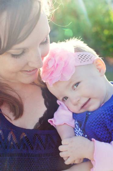 mother and baby daughter with brain cancer smiling