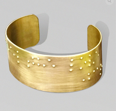 Golden Cuff with "feel the love" printed in braille