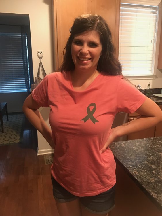 woman at home wearing a red gastroparesis awareness shirt