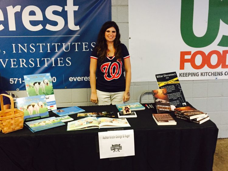 woman standing at author table with books she's written