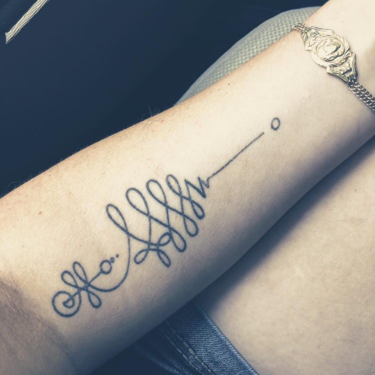 unalome symbol tattoo on arm