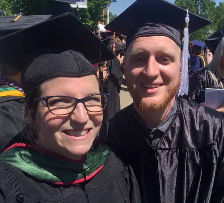 professor and student smiling at graduation