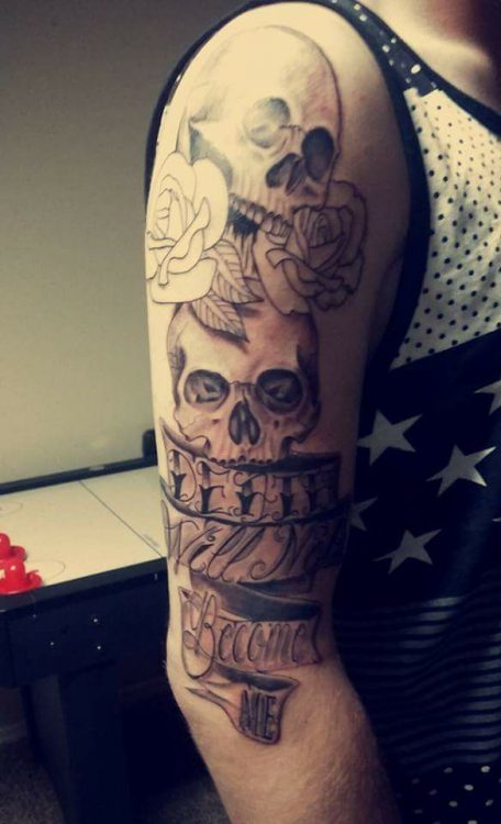 skulls and roses tattoo on upper arm
