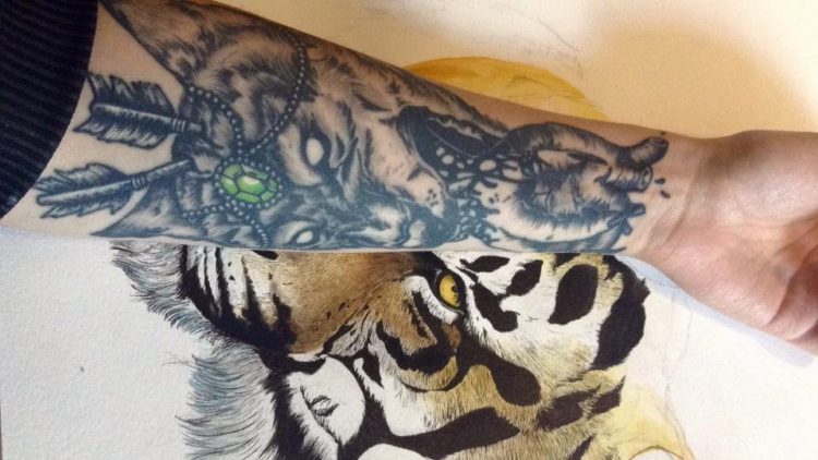 tiger and heart tattoo on forearm