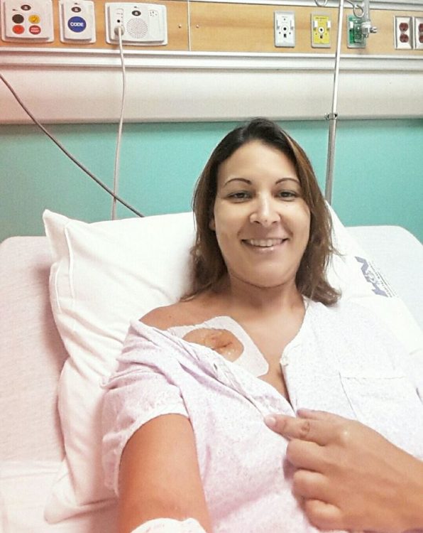 woman smiling in a hospital bed