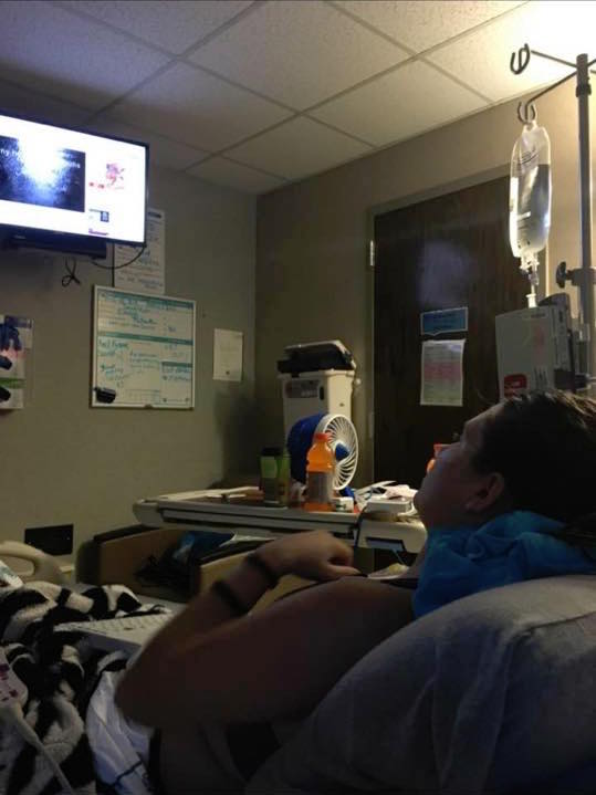 woman watching tv from her hospital bed