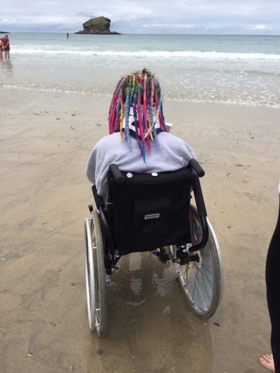 woman sitting in a wheelchair on the beach