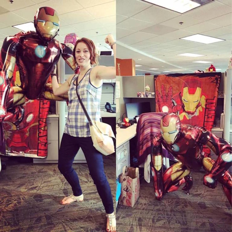 The writer of the article at her desk, decorated with Iron man items.