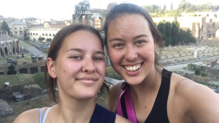 two women taking a photo in front of the roman forum