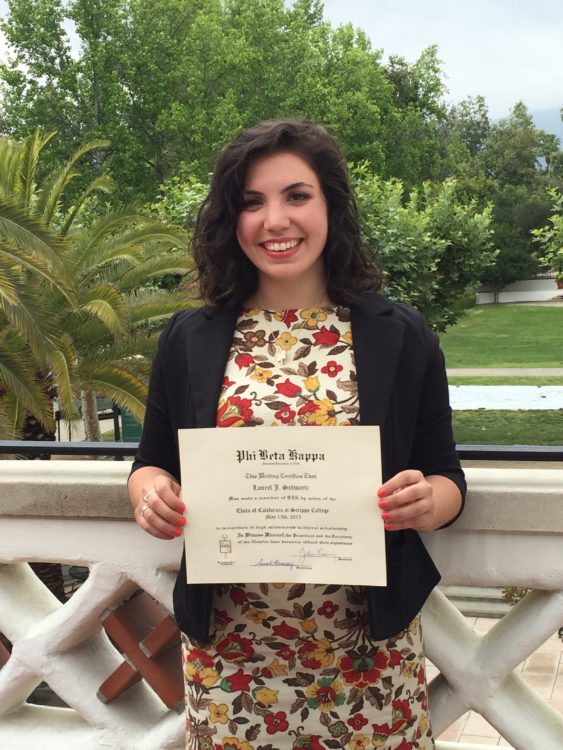 woman holding her college diploma