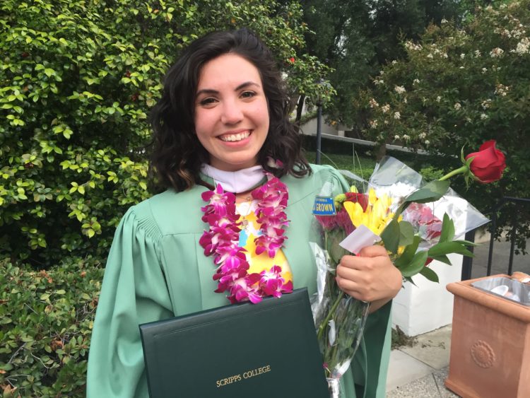 woman in her cap and gown after college graduation