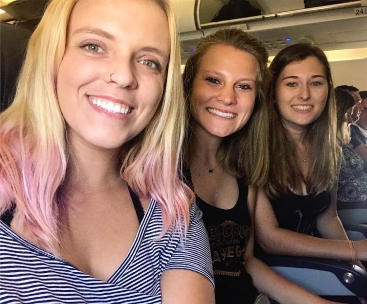friends sitting on an airplane