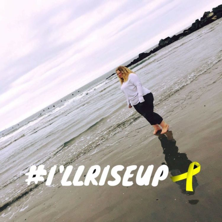 The writer walking on the beach, with a hashtag that reads, "I'll rise up."