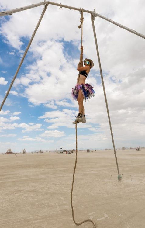 woman climbing on ropes at the beach