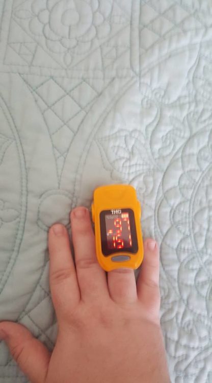 woman wearing heart rate monitor on her finger